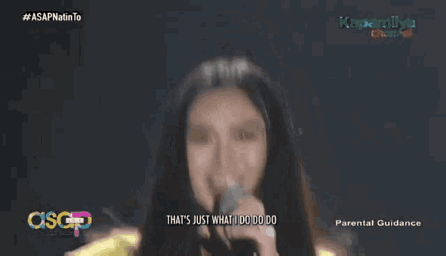 a woman singing into a microphone with the words " that 's just what i do do do "