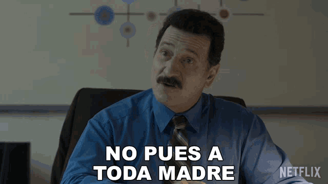 a man in a blue shirt and tie says no pues a toda madre in spanish