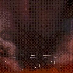 a close up of a red explosion with a black background