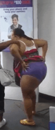 a woman in purple shorts and a white tank top is standing in front of a sign that says 100 dollars .