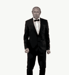 a man in a tuxedo and bow tie is standing with his fists in the air .