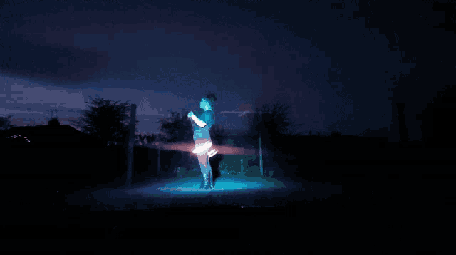 a man is doing a handstand in the dark