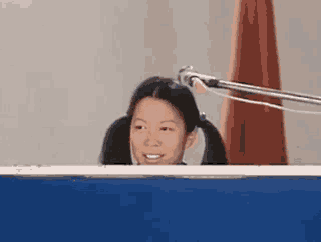 a girl with pigtails behind a microphone