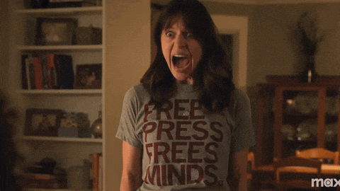 a woman wearing a t-shirt that says free press frees minds
