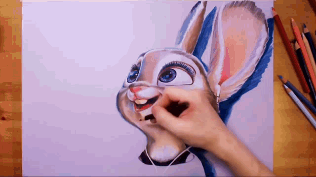 a person is drawing a bunny with headphones on a piece of paper