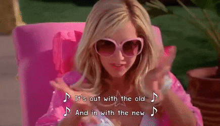 a woman wearing sunglasses and a pink jacket is singing it 's out with the old and in with the new song