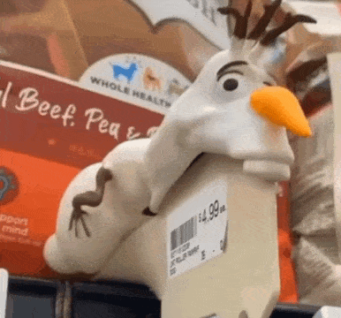 a toy that looks like olaf from frozen is sitting on a shelf in a store .