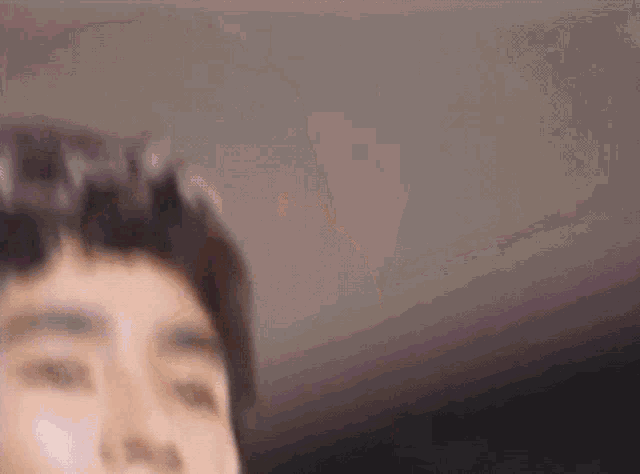 a blurry photo of a person 's face with purple hair