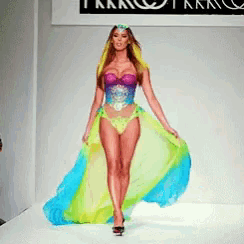 a pixelated image of a woman walking down a runway with a sign that says tkk on it