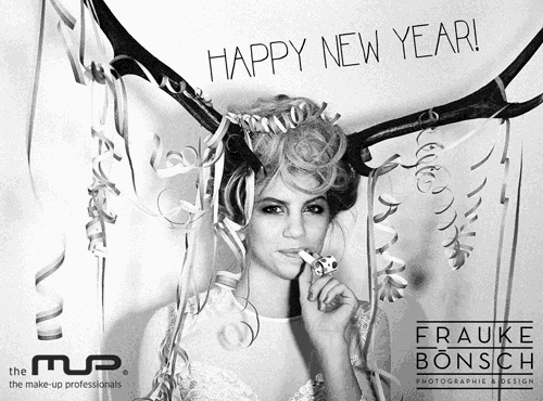 a black and white photo of a woman with a horn on her head and the words happy new year
