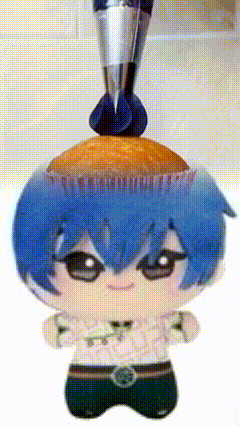 a stuffed doll with a cupcake on top of it