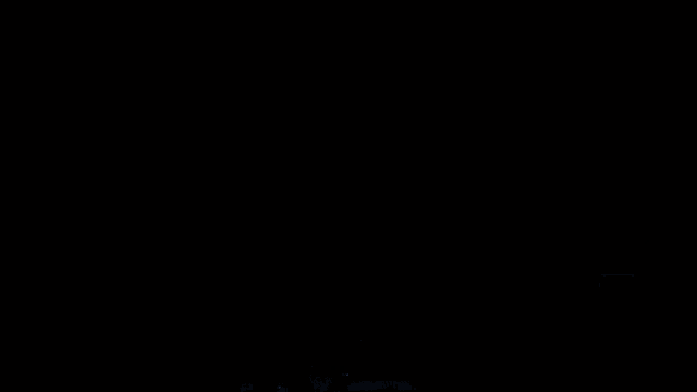 a person standing in a dark room with a light coming out of it