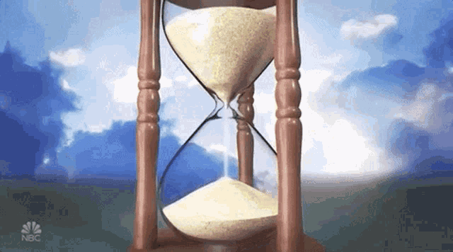 a hourglass with nbc written on the bottom