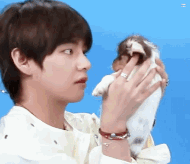 a close up of a person holding a small dog