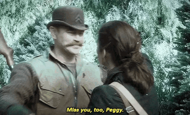 a man with a mustache is talking to a woman in a forest and says `` miss you too , peggy '' .