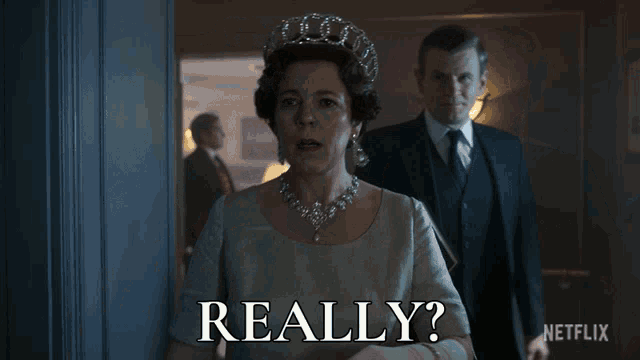 a woman with a crown on her head is standing next to a man with a book and the words " really " written below her