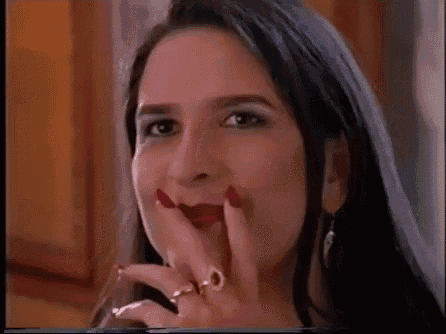 a close up of a woman 's face with red lips and a ring on her finger