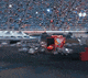 a blurred image of a red truck parked in a parking lot .