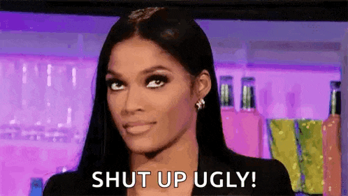 a woman with long black hair is making a funny face and says `` shut up ugly '' .