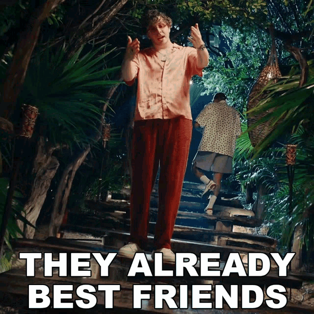 a man standing on a set of stairs with the words they already best friends behind him