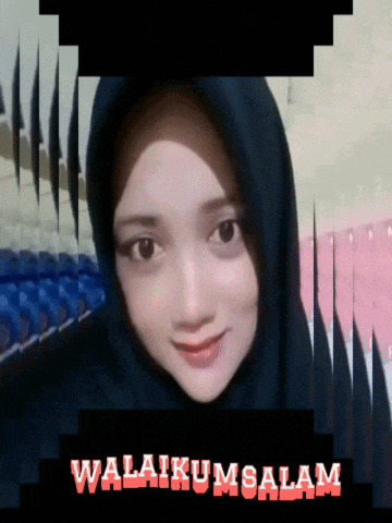a woman wearing a black hijab is smiling in front of a sign that says " awalikumsalam "