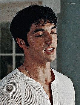 a close up of a man 's face with his eyes closed and his mouth open .