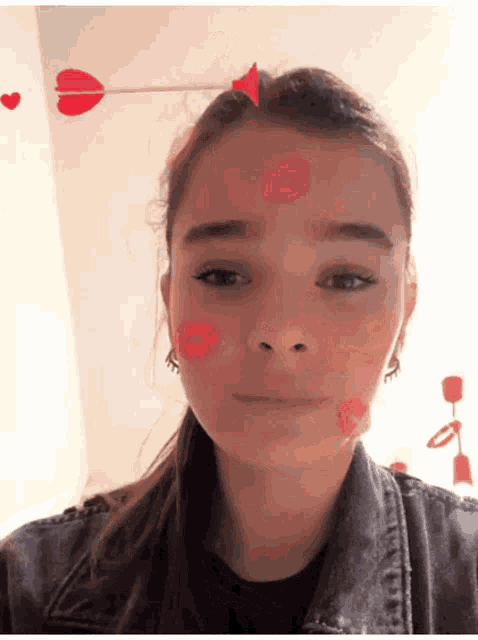 a girl with hearts on her face and a cupid arrow in her hair