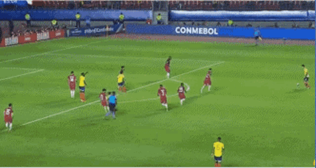 a group of soccer players on a field with an ad for gol