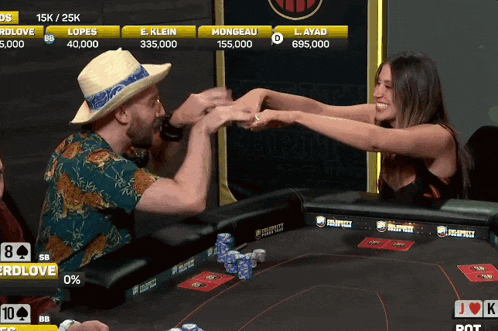 a man and a woman fist bump at a poker table with the numbers 15k and 25k visible