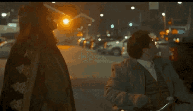a blurry picture of people walking down a street with the words fucking guy