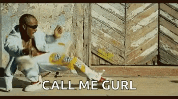 a man is kneeling down on the ground in front of a wooden wall and a sign that says `` call me gurl '' .
