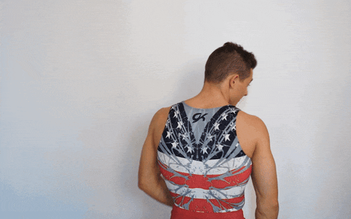 a man is wearing a tank top with the letter k on it