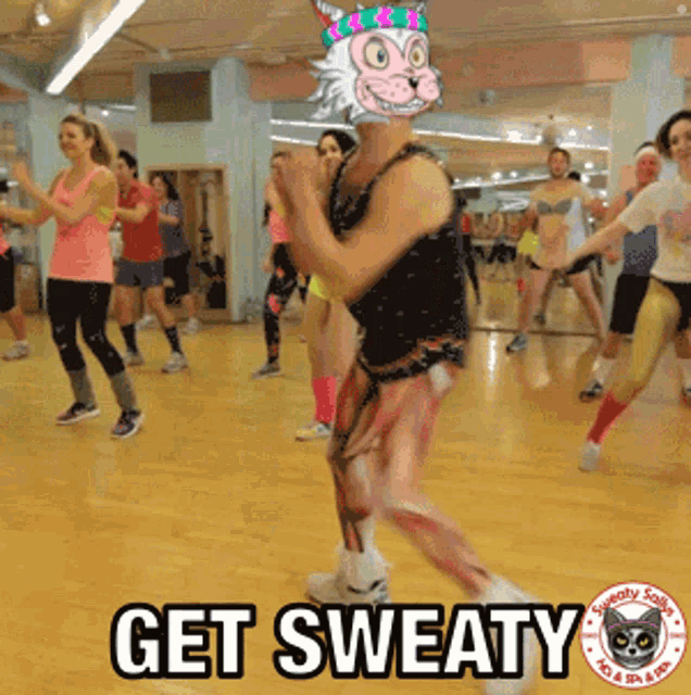 a group of people are dancing in a gym with the words get sweaty written on the bottom