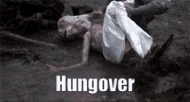 a person is laying on the ground with the word hangover written on the bottom .