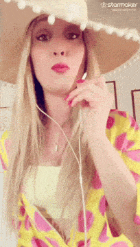 a woman wearing a straw hat and a yellow shirt with a starmaker logo