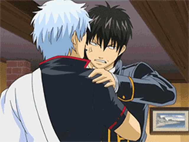 two anime characters are hugging each other in a living room