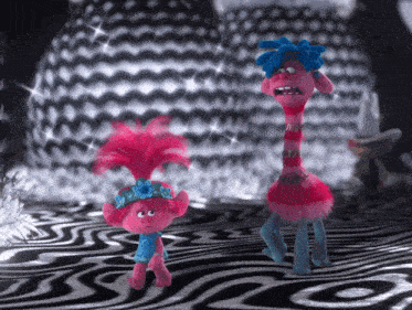 two trolls standing on a zebra print floor