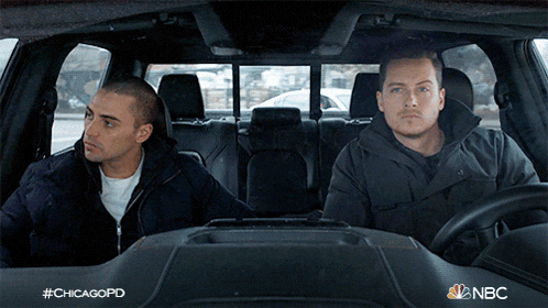 two men in a car with #chicagopd on the bottom right
