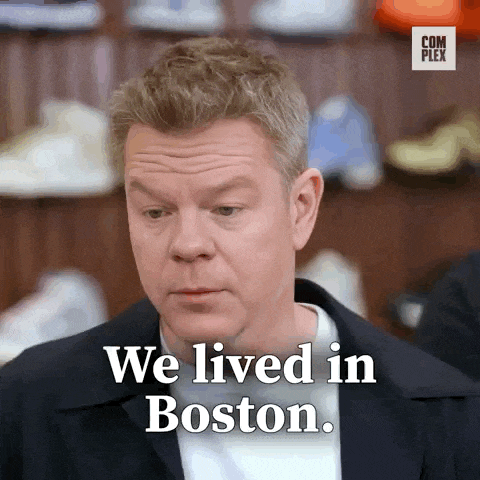 a man says " we lived in boston " in front of a display of shoes