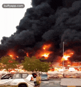 a white suv with the word police on the back is parked in front of a fire