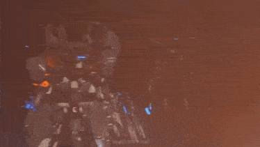 a close up of a painting of a fire with a blurred background