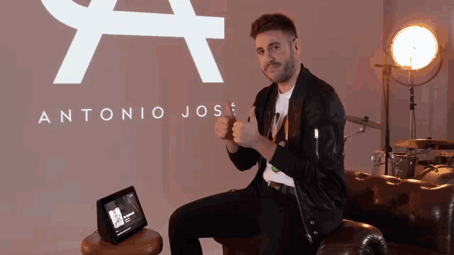 a man giving a thumbs up in front of antonio jose