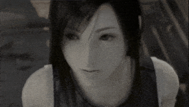 a close up of a woman 's face in a black and white photo