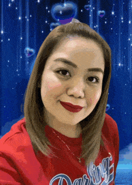 a woman wearing a red darling sweatshirt looks at the camera