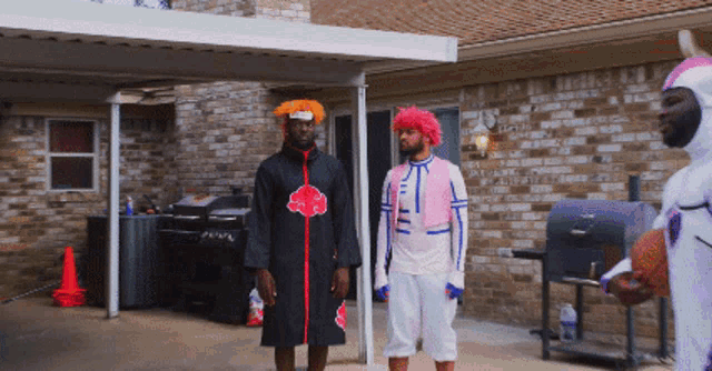 a man in a clown costume holds a basketball in front of a brick house