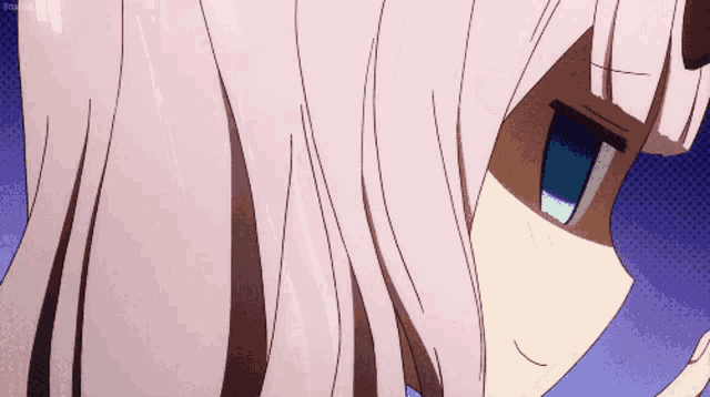 a close up of a person 's face with a blue eye