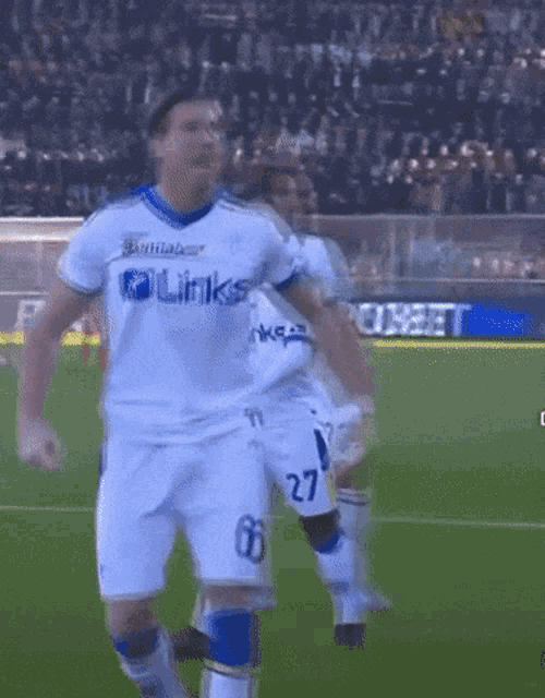 a soccer player wearing a white jersey with the word links on it
