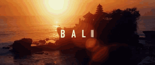 a sunset over the ocean with the word bali on the bottom