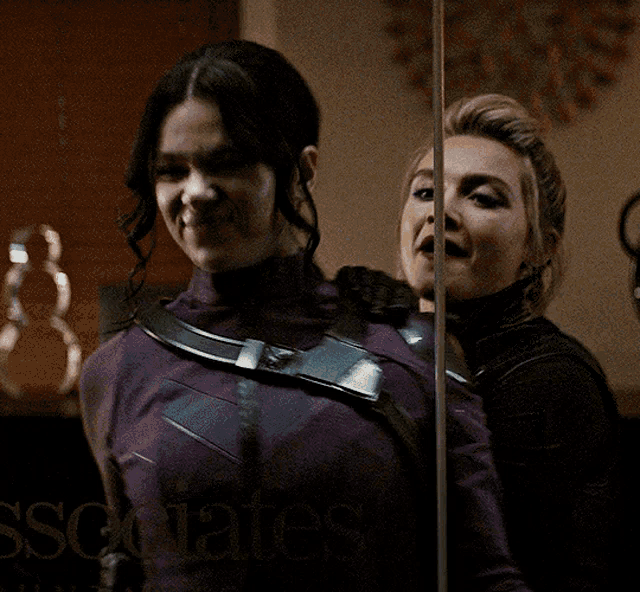 two women are standing next to each other and the word associates is on the bottom