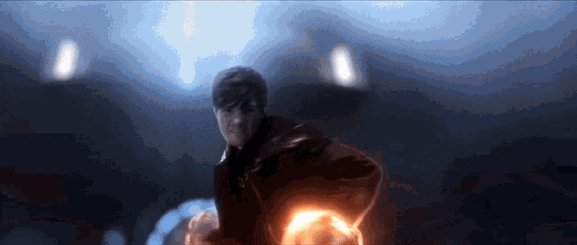 a blurry picture of a man holding a light in his hand